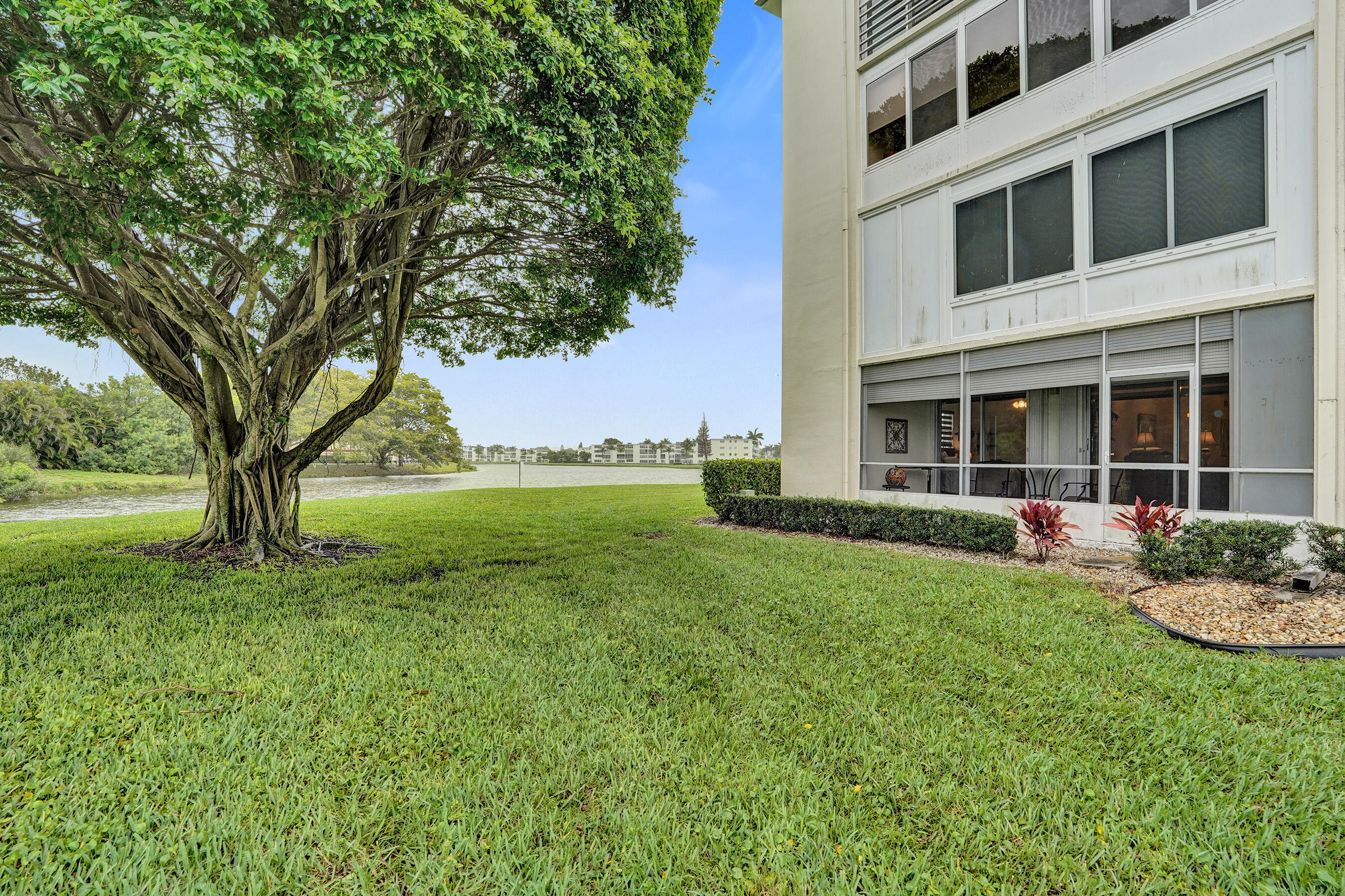 1033 Ainslie C Boca Raton, FL 33434 - Photo 39 of 42 a view of a house with backyard porch and garden