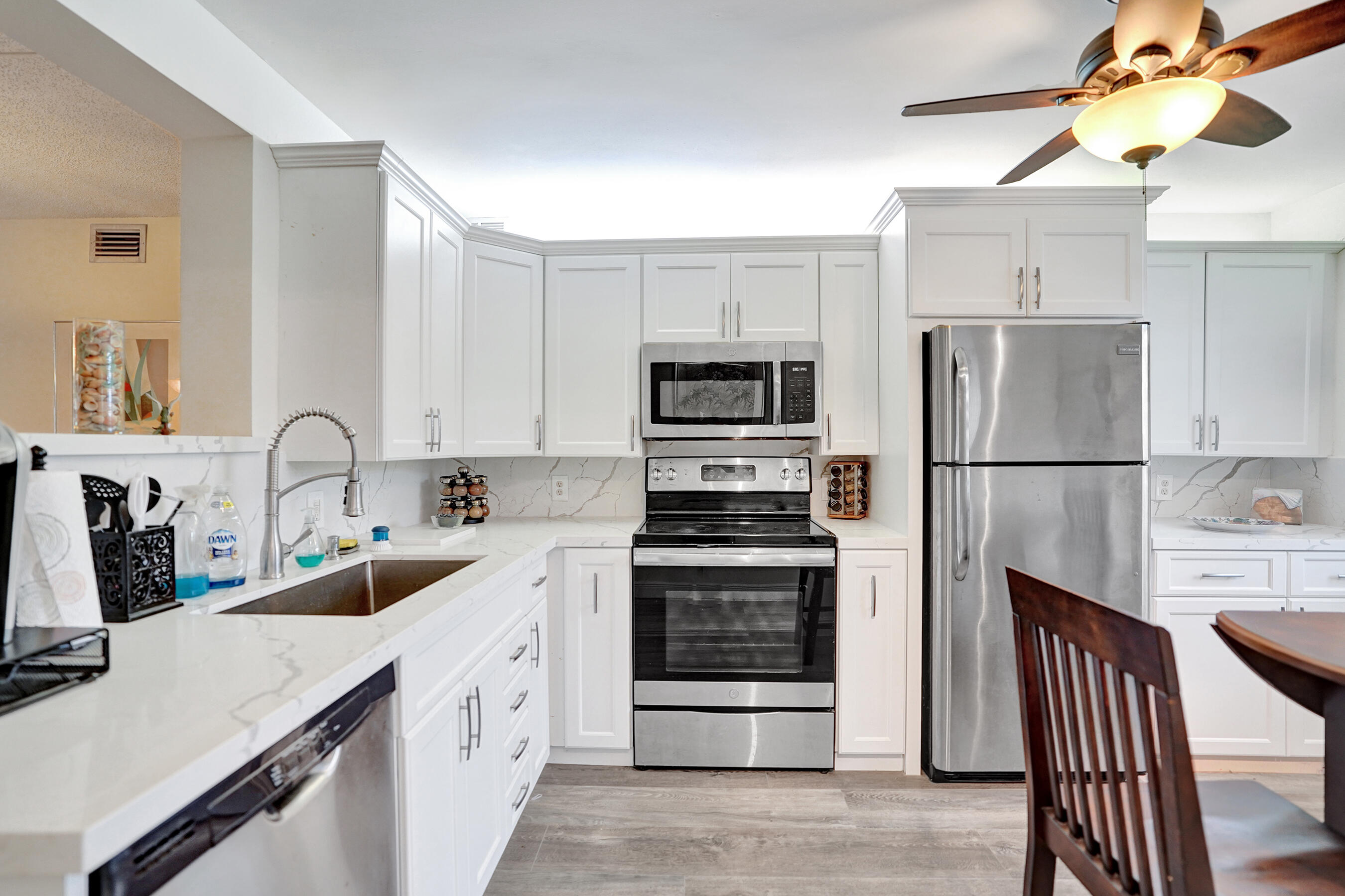 1033 Ainslie C Boca Raton, FL 33434 - Photo 4 of 42 a kitchen with stainless steel appliances sink and refrigerator