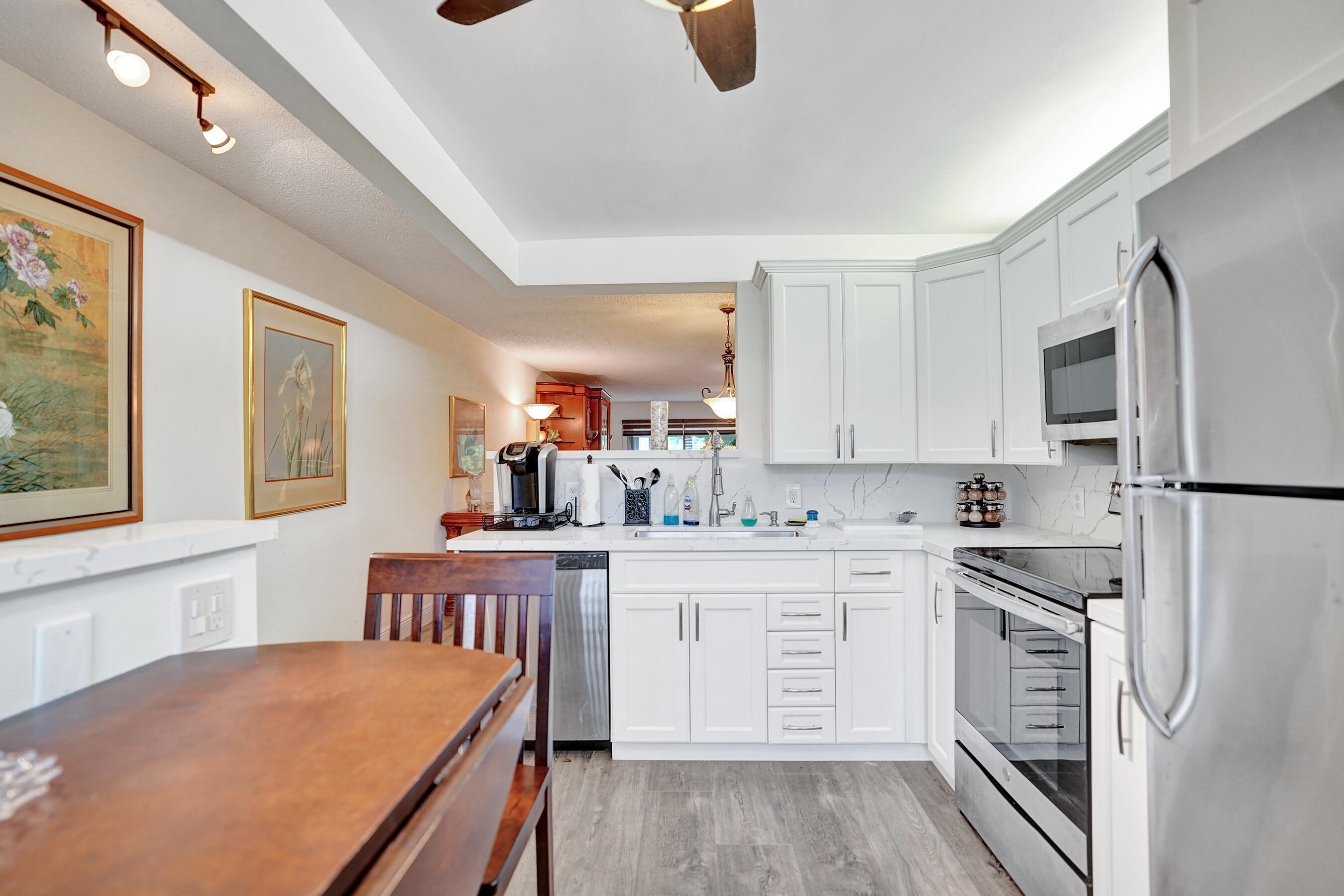 1033 Ainslie C Boca Raton, FL 33434 - Photo 8 of 42 a kitchen with a sink stove and cabinets