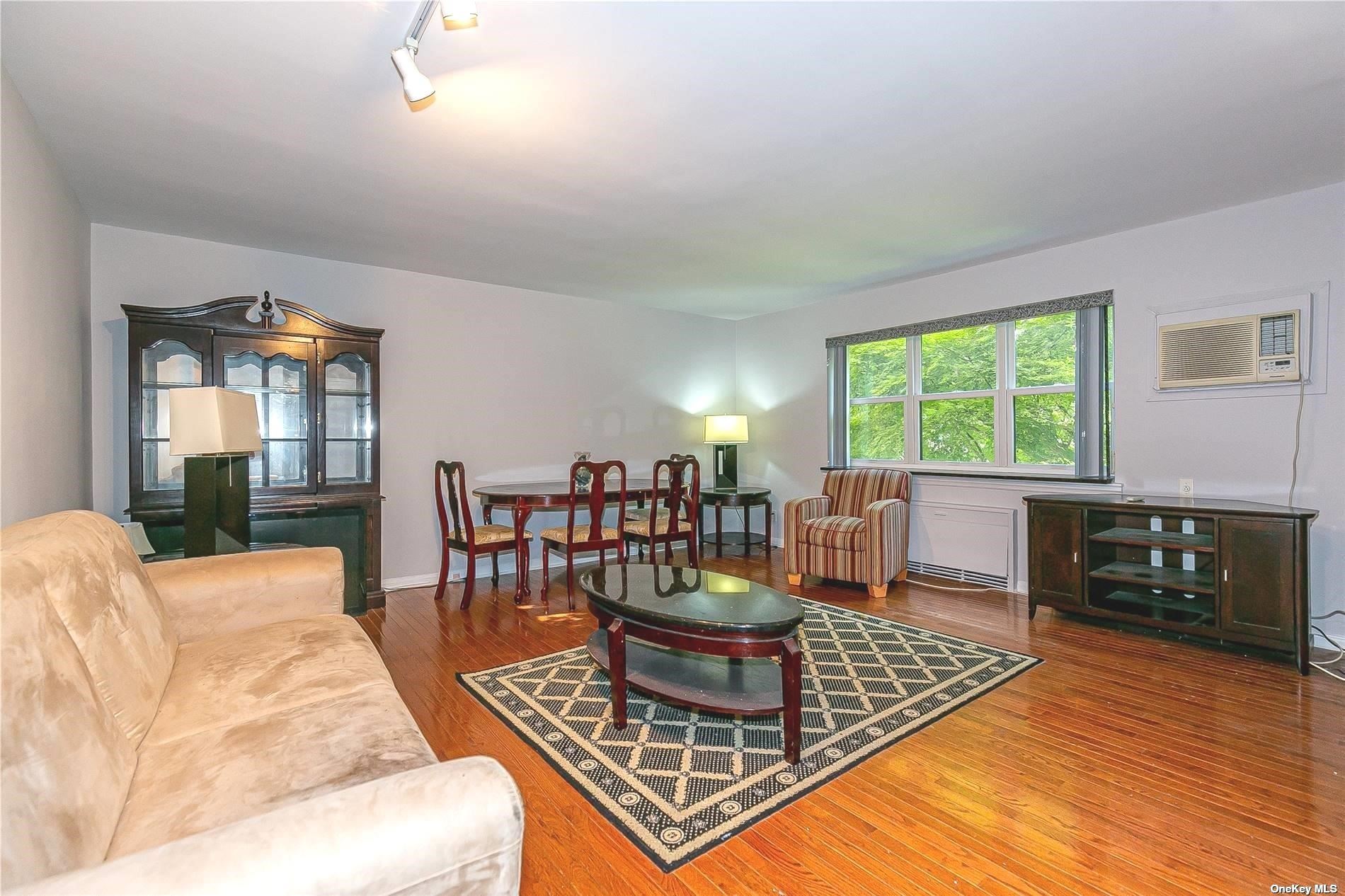 15 Beach Road, Unit 2D Great Neck, NY 11023 - Photo 1 of 1 a living room with furniture and a fireplace