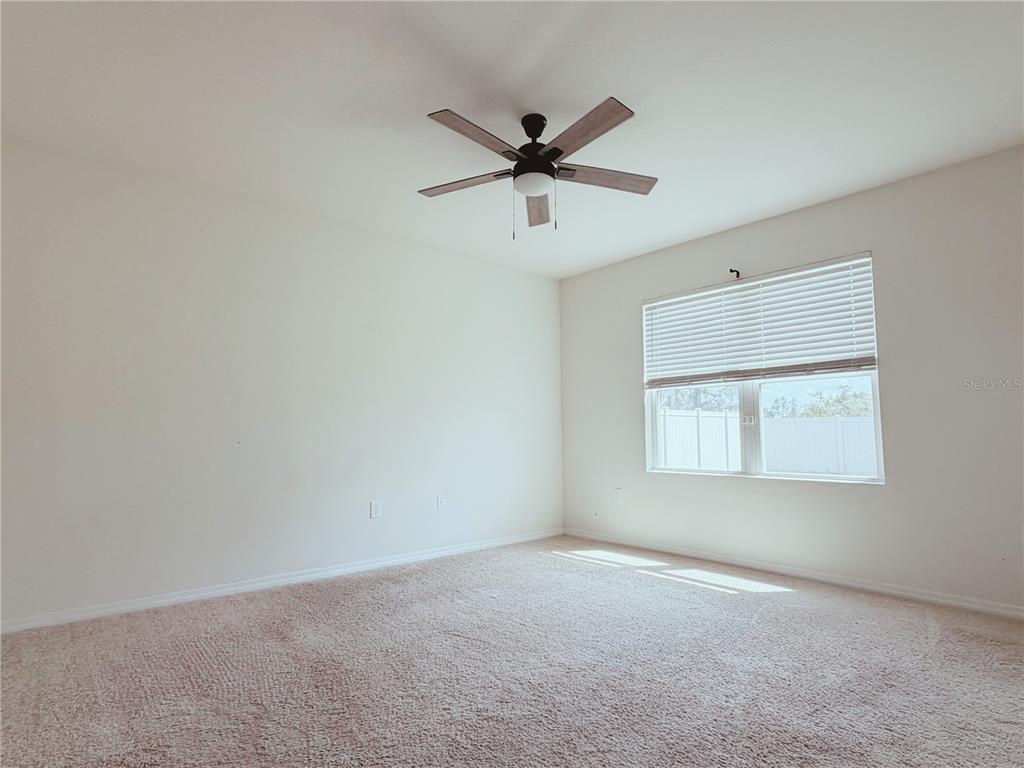910 Sun Burst Road Winter Haven, FL 33880 - Photo 6 of 14 a view of a livingroom with a ceiling fan and window