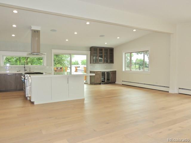 3255 Field Street Wheat Ridge, CO 80033 - Photo 11 of 35 an empty room with kitchen view and windows