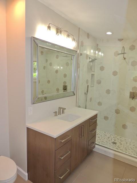 3255 Field Street Wheat Ridge, CO 80033 - Photo 23 of 35 a bathroom with a sink mirror vanity and toilet