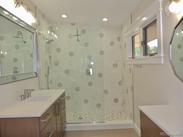 3255 Field Street Wheat Ridge, CO 80033 - Photo 24 of 35 a bathroom with a bathtub shower sink and mirror