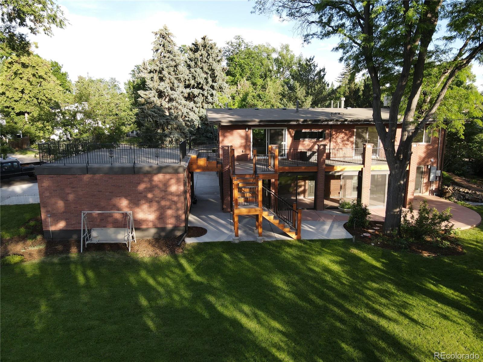 3255 Field Street Wheat Ridge, CO 80033 - Photo 6 of 35 a view of a backyard with wooden fence and a large tree