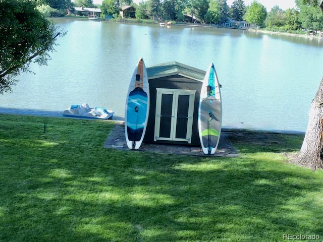 3255 Field Street Wheat Ridge, CO 80033 - Photo 10 of 35 a view of a house with a yard and a pond
