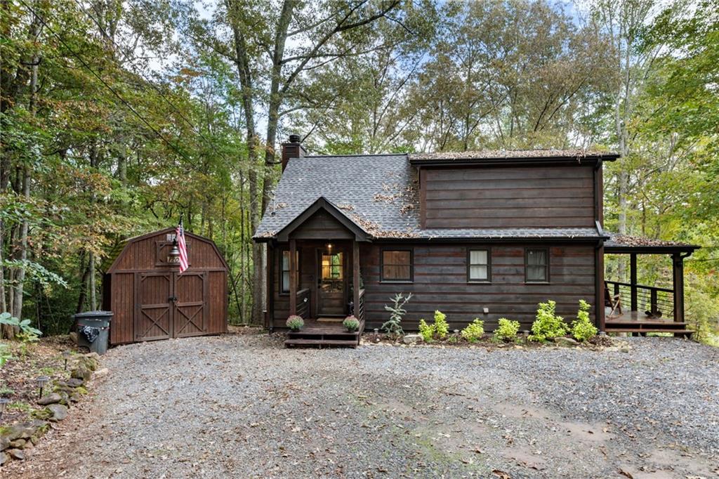 120 Brookhaven Trail Blue Ridge, GA 30513 - Photo 2 of 100 a front view of a house with swing plants and wooden fence