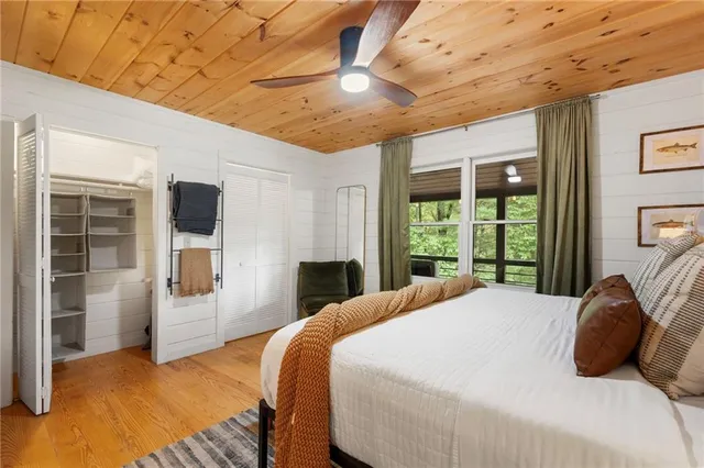 a bedroom with furniture and a large window