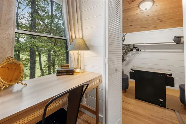 a bedroom with a large bed couch and a flat screen tv