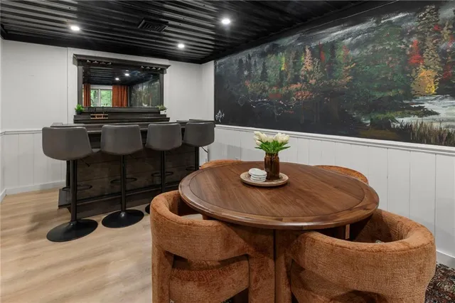 a view of a lake with lawn chairs and a table