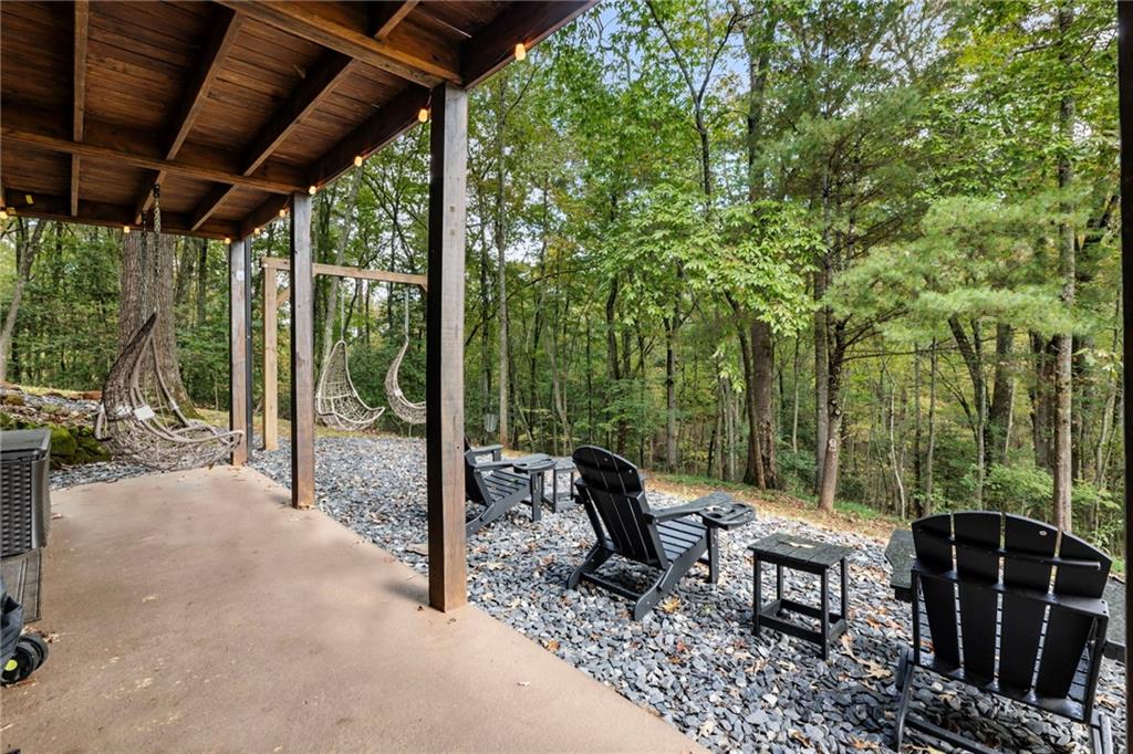 120 Brookhaven Trail Blue Ridge, GA 30513 - Photo 69 of 100 a view of a patio with a table chairs and a backyard
