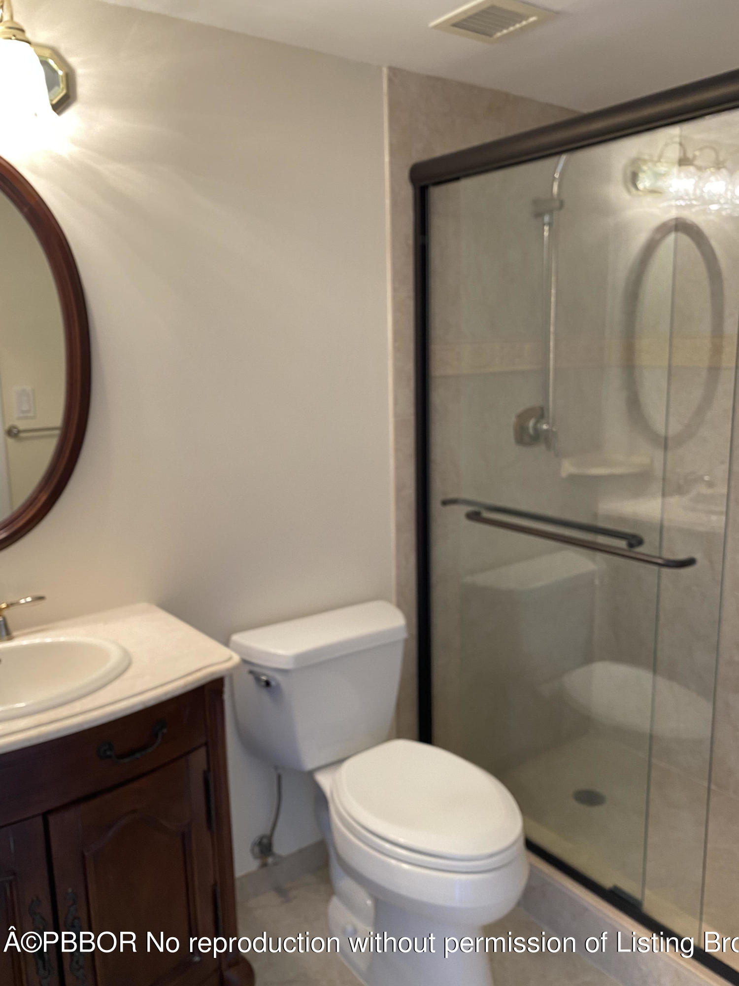 3800 Washington Road, Unit 610 West Palm Beach, FL 33405 - Photo 12 of 13 a white toilet sitting next to a bathroom sink