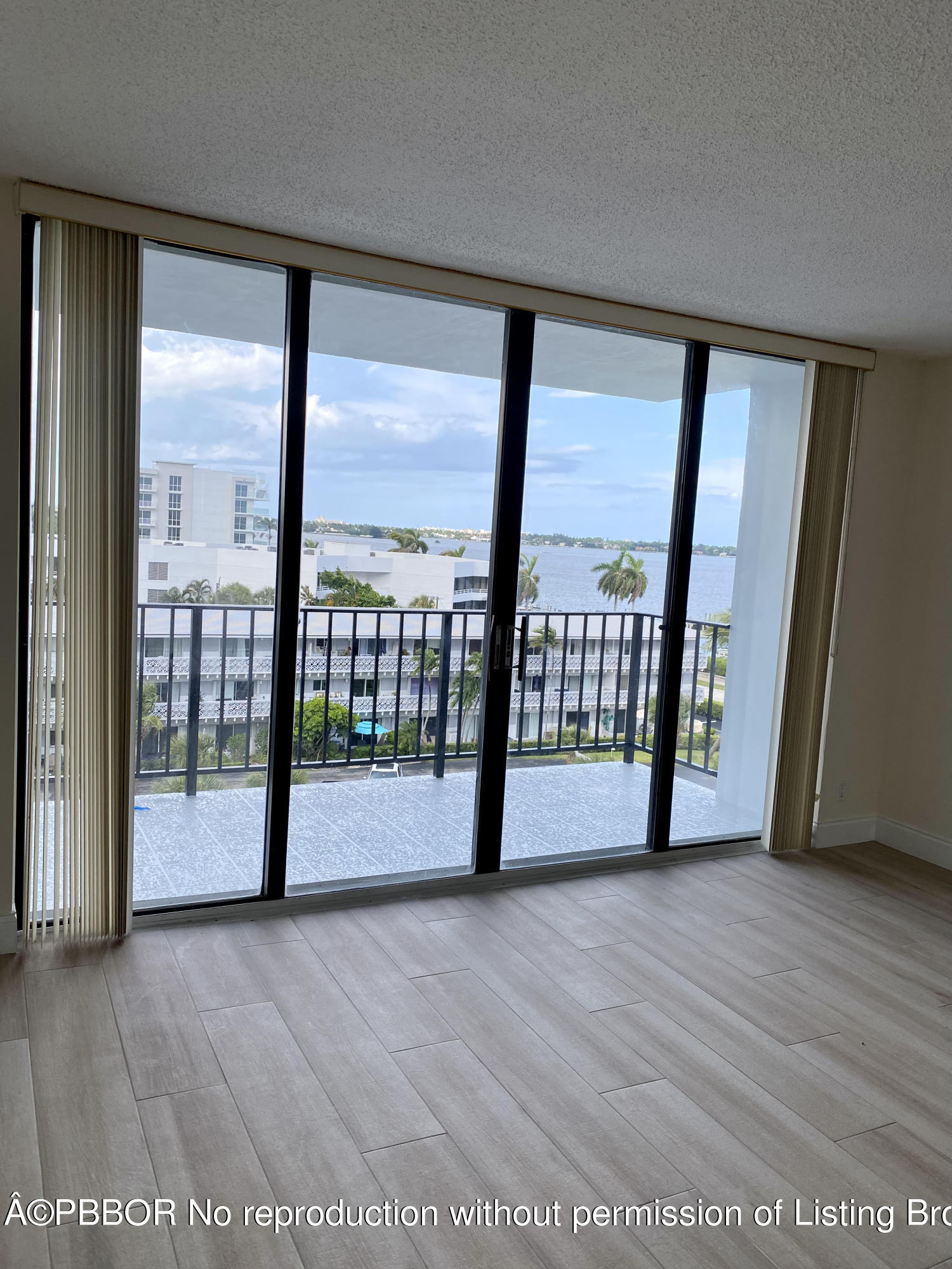 3800 Washington Road, Unit 610 West Palm Beach, FL 33405 - Photo 5 of 13 a view of hallway with wooden floor and door
