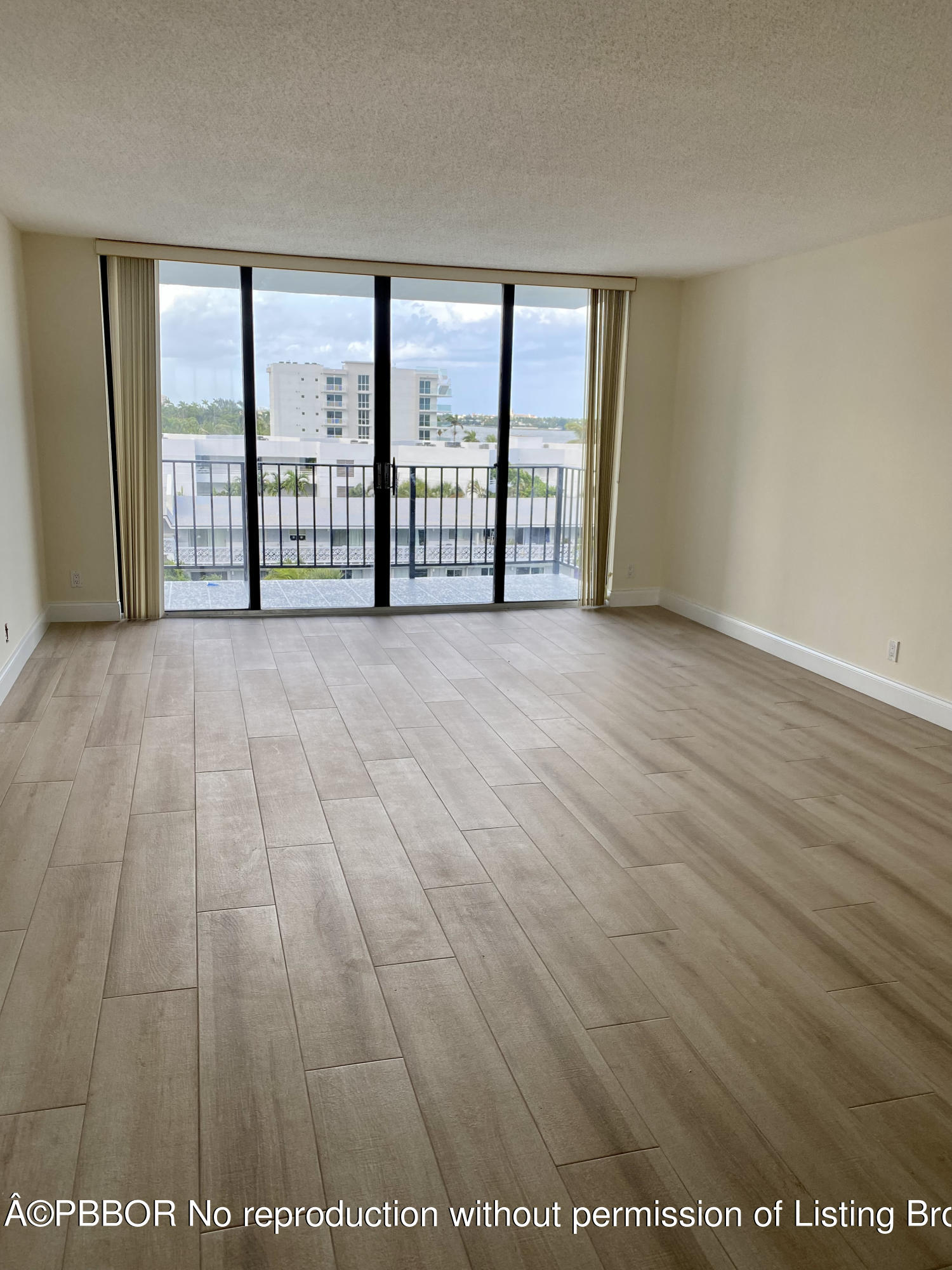 3800 Washington Road, Unit 610 West Palm Beach, FL 33405 - Photo 6 of 13 an empty room with large windows