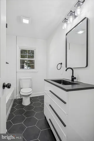 a bathroom with a toilet and a bathtub