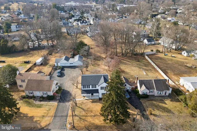 an aerial view of a house with a yard and lake view