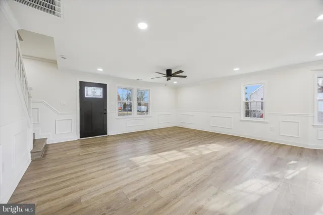 a large kitchen with kitchen island a sink a center island stainless steel appliances and a window