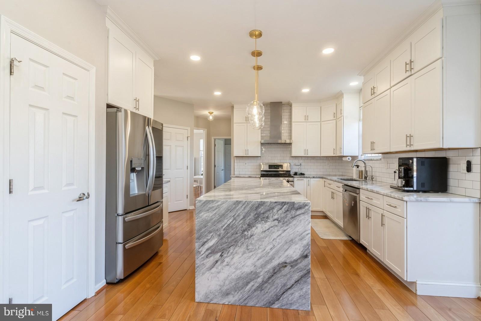 32 Moorsgate Circle Hightstown, NJ 08520 - Photo 12 of 49 a large kitchen with stainless steel appliances and a refrigerator