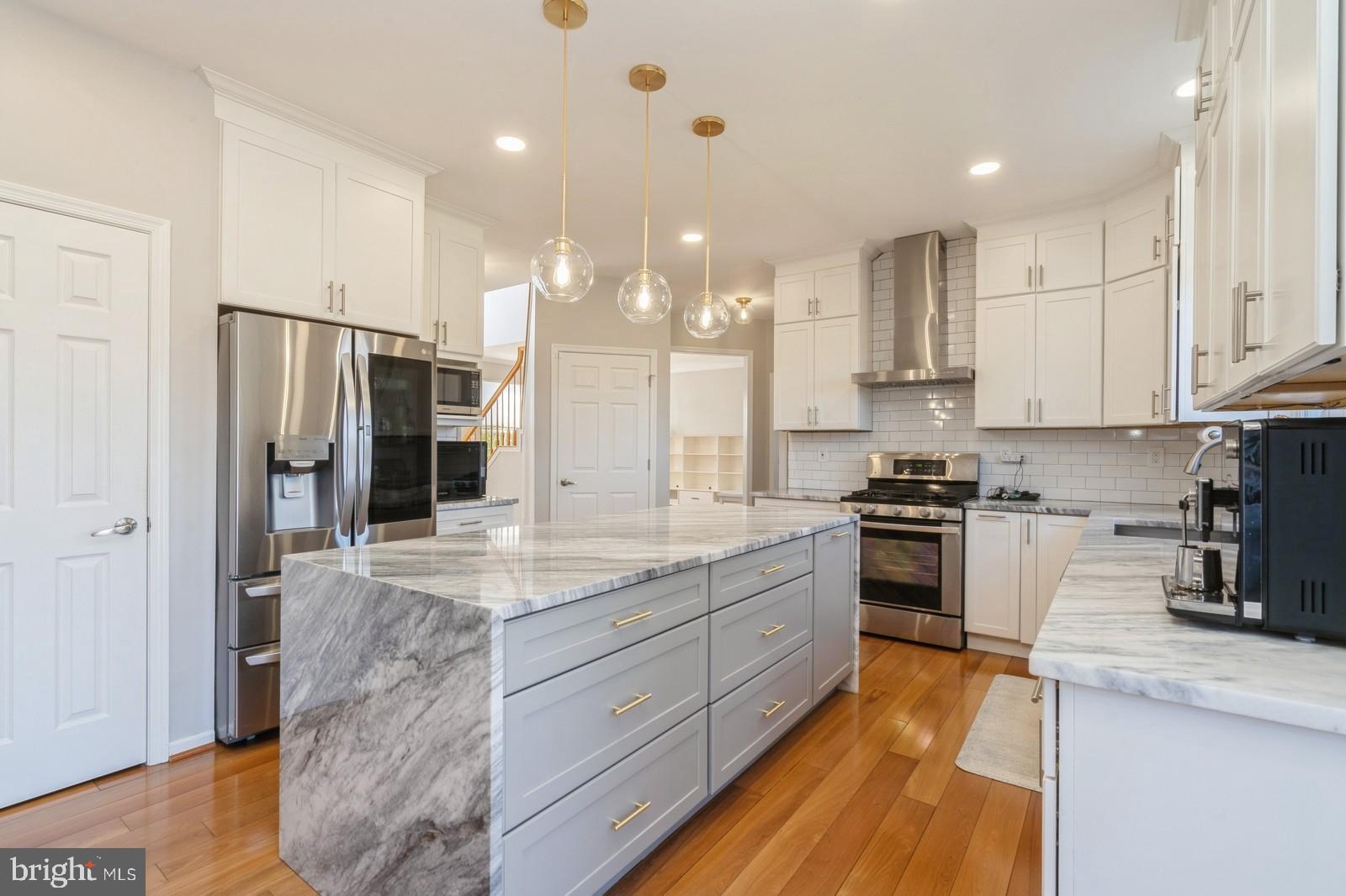 32 Moorsgate Circle Hightstown, NJ 08520 - Photo 13 of 49 a kitchen with stainless steel appliances kitchen island granite countertop a stove refrigerator and cabinets