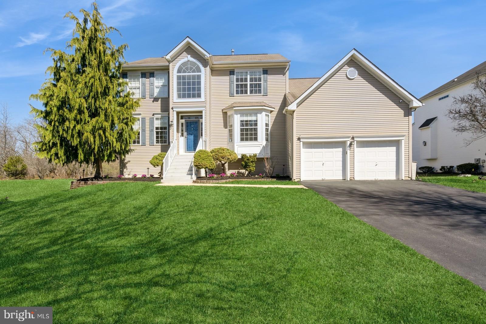 32 Moorsgate Circle Hightstown, NJ 08520 - Photo 2 of 49 a front view of a house with a yard