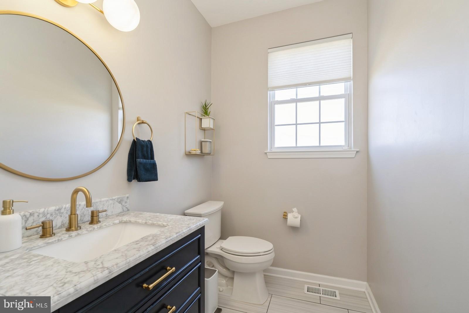 32 Moorsgate Circle Hightstown, NJ 08520 - Photo 22 of 49 a bathroom with a granite countertop sink mirror vanity and toilet