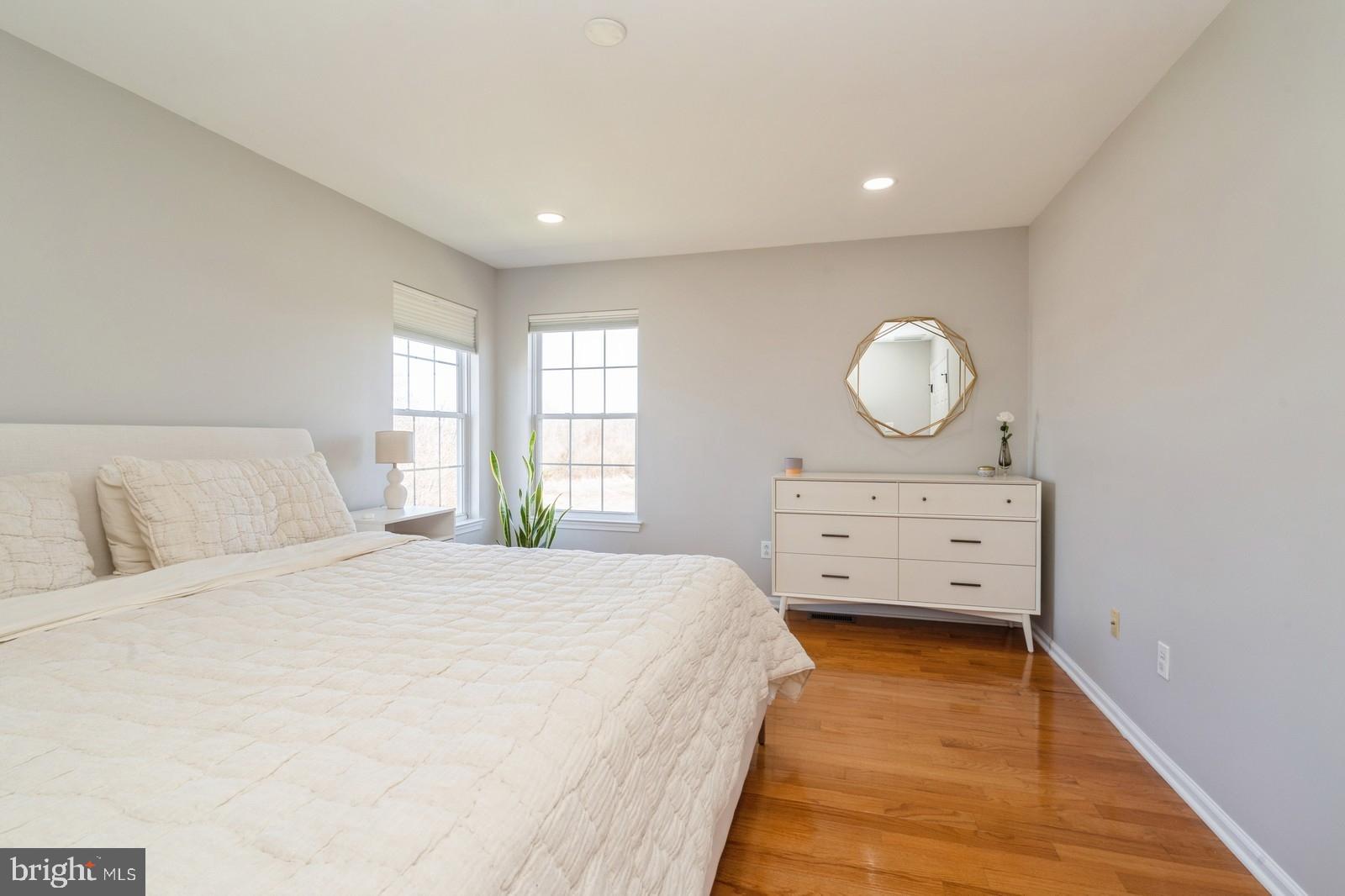 32 Moorsgate Circle Hightstown, NJ 08520 - Photo 24 of 49 a bedroom with a bed and wooden floor