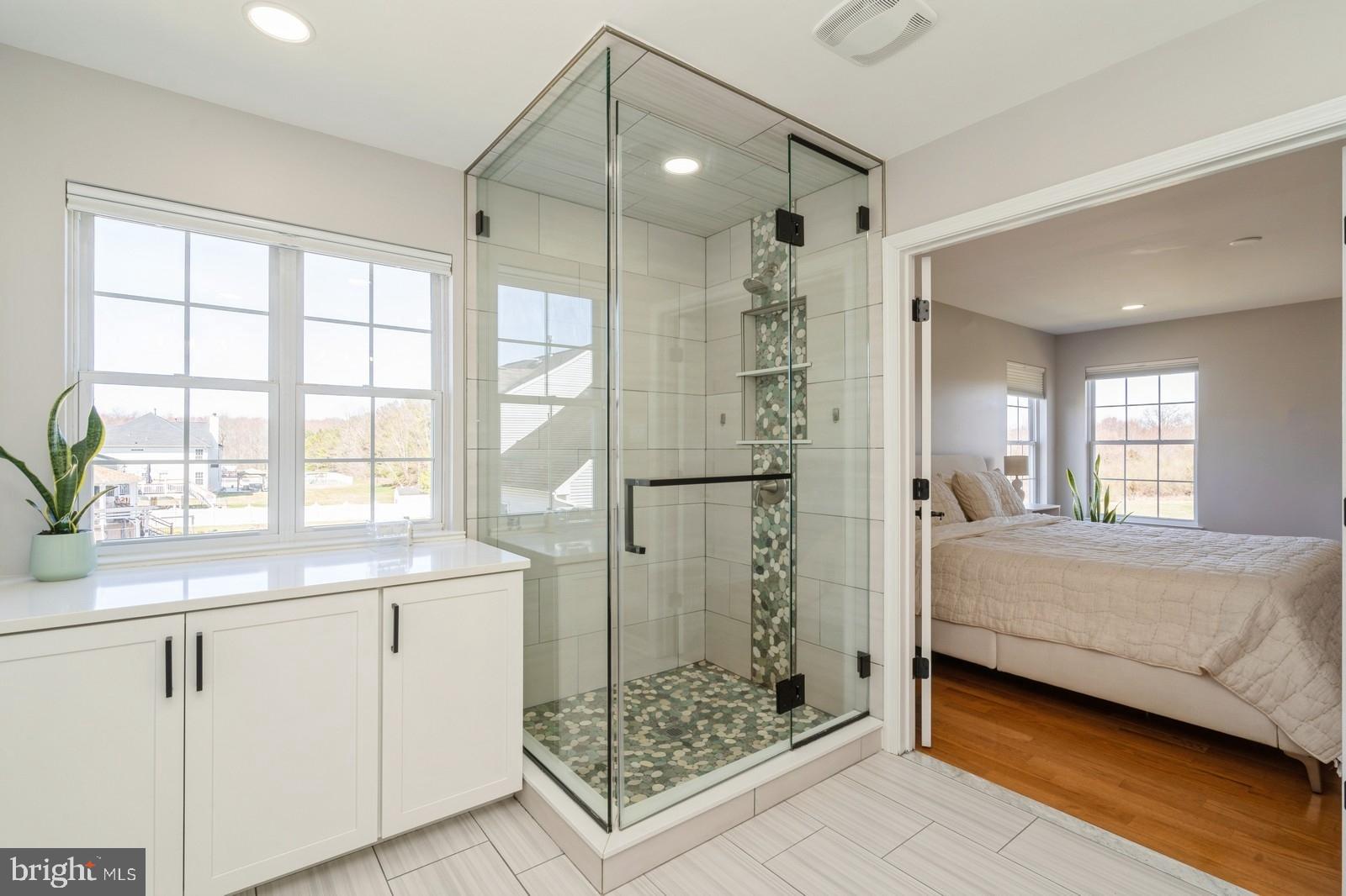 32 Moorsgate Circle Hightstown, NJ 08520 - Photo 27 of 49 a en suite bathroom with sink glass door and chandelier
