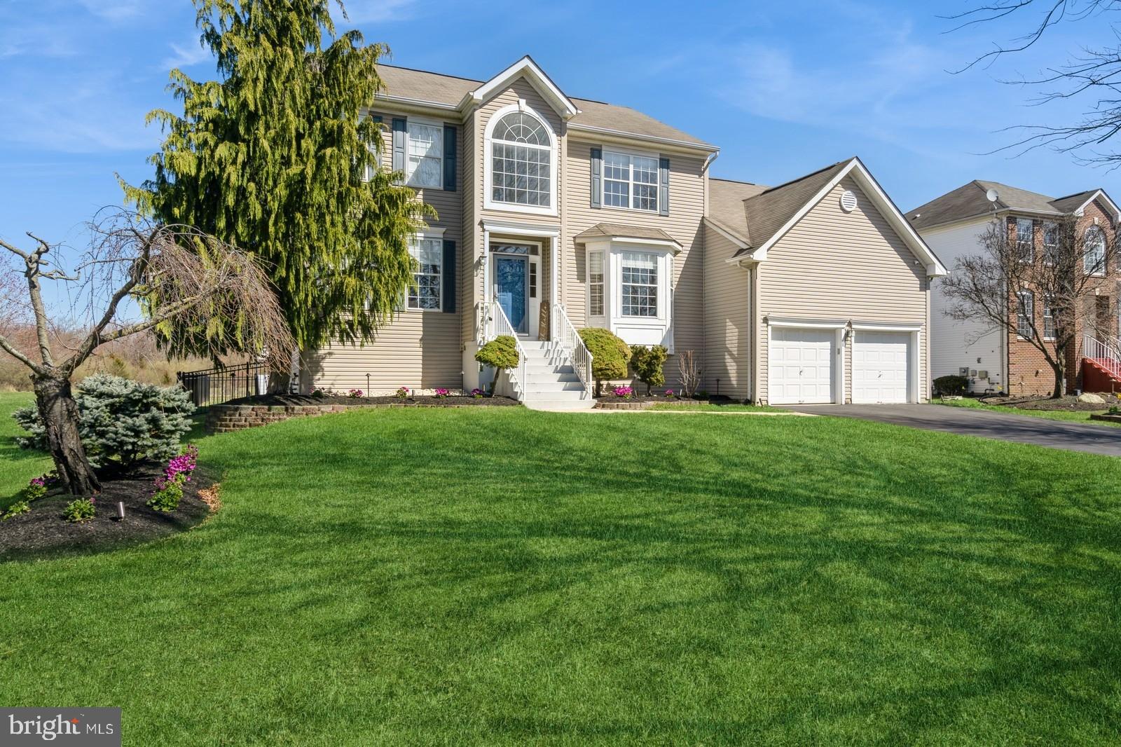 32 Moorsgate Circle Hightstown, NJ 08520 - Photo 3 of 49 a front view of a house with a yard and trees