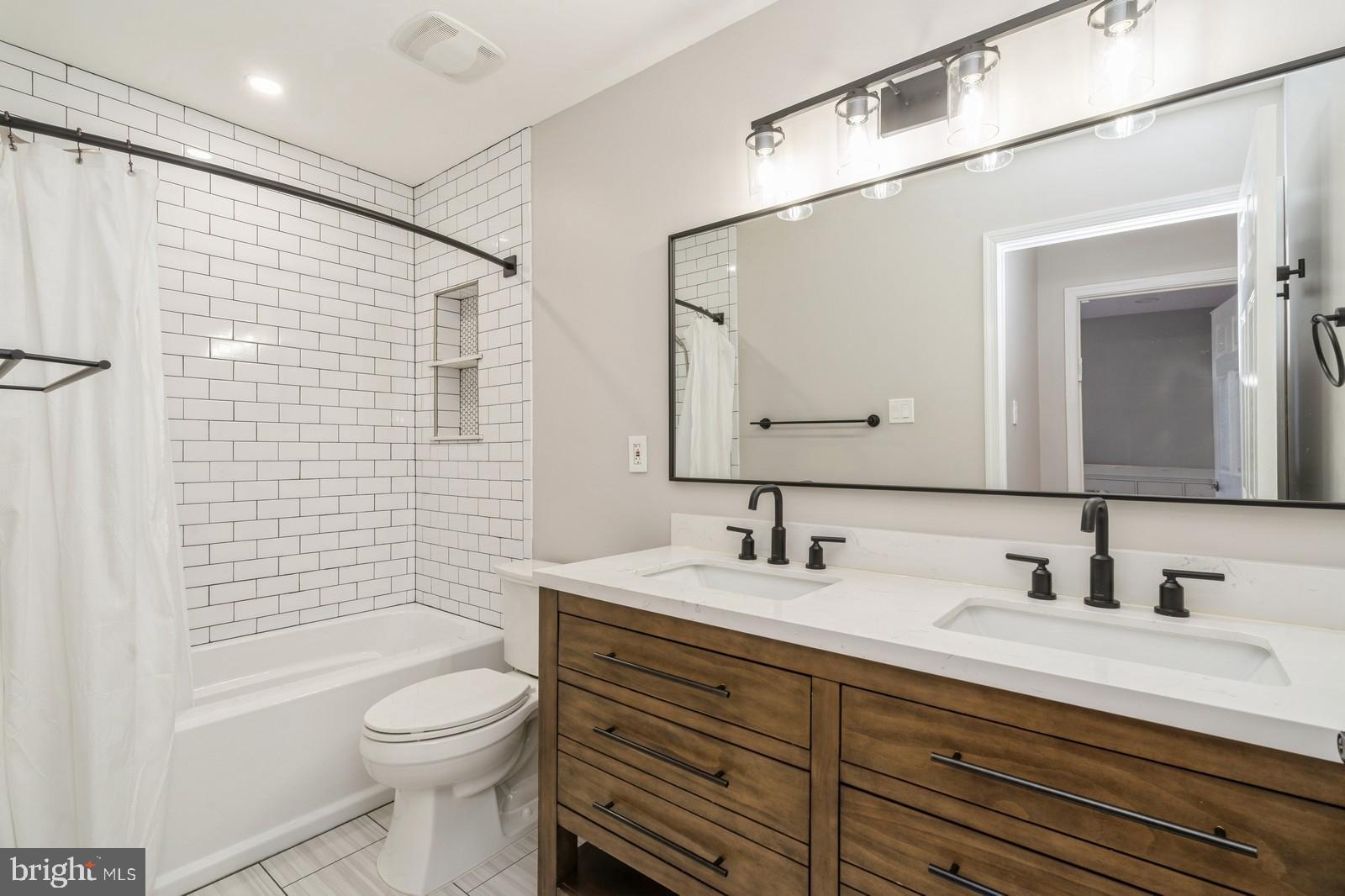 32 Moorsgate Circle Hightstown, NJ 08520 - Photo 33 of 49 a bathroom with a toilet a sink a mirror a shower a vanity and mirror