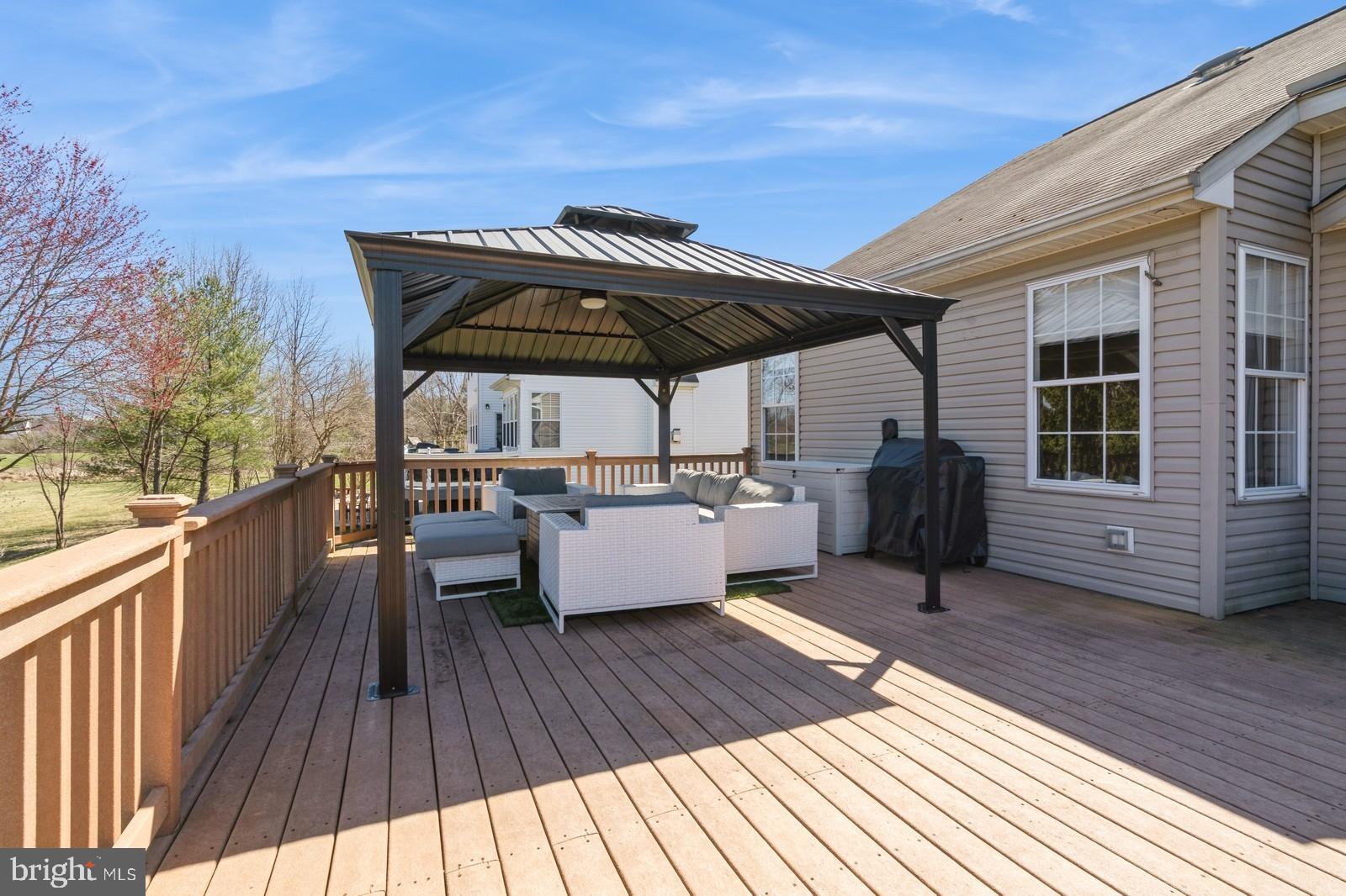 32 Moorsgate Circle Hightstown, NJ 08520 - Photo 45 of 49 a view of a roof deck with wooden floor and barbeque oven