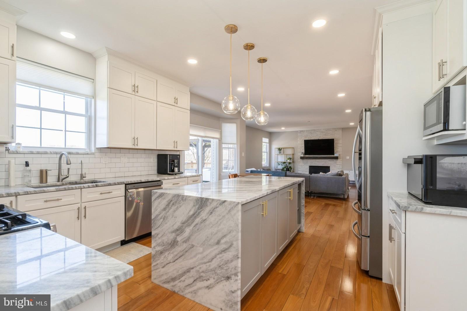 32 Moorsgate Circle Hightstown, NJ 08520 - Photo 10 of 49 a large kitchen with stainless steel appliances lots of counter space and a sink