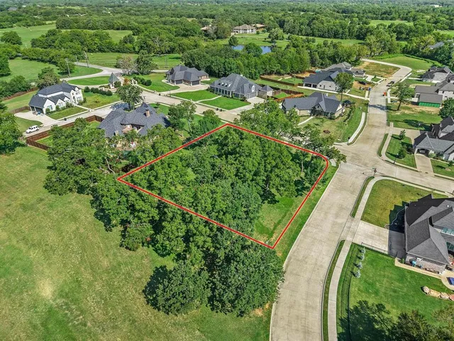 an aerial view of residential houses with outdoor space and street view