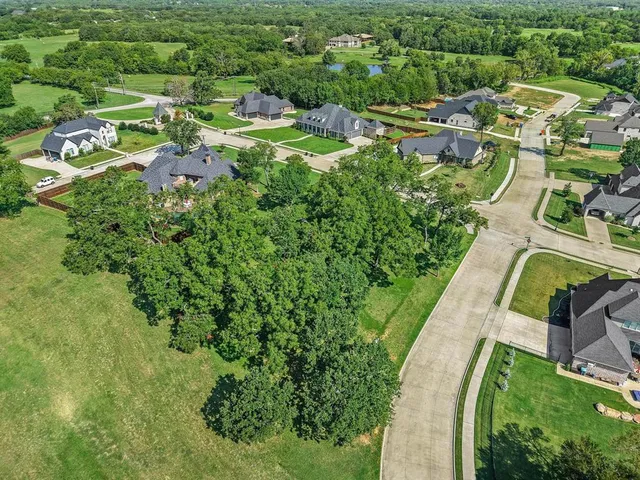 an aerial view of residential houses with outdoor space and street view