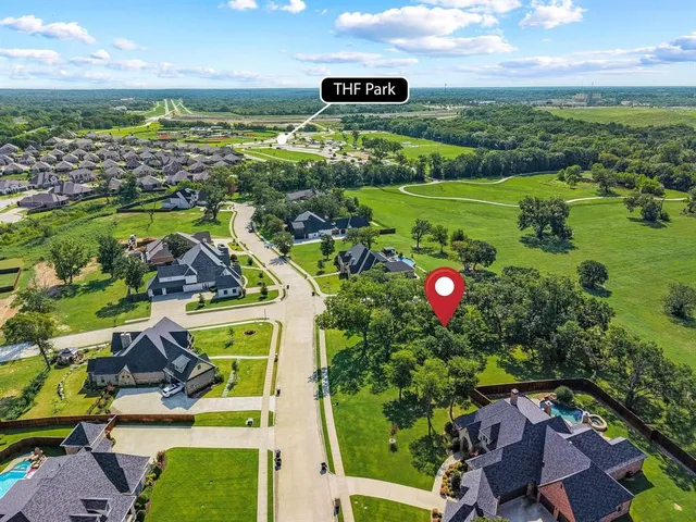 an aerial view of residential houses with outdoor space and pool