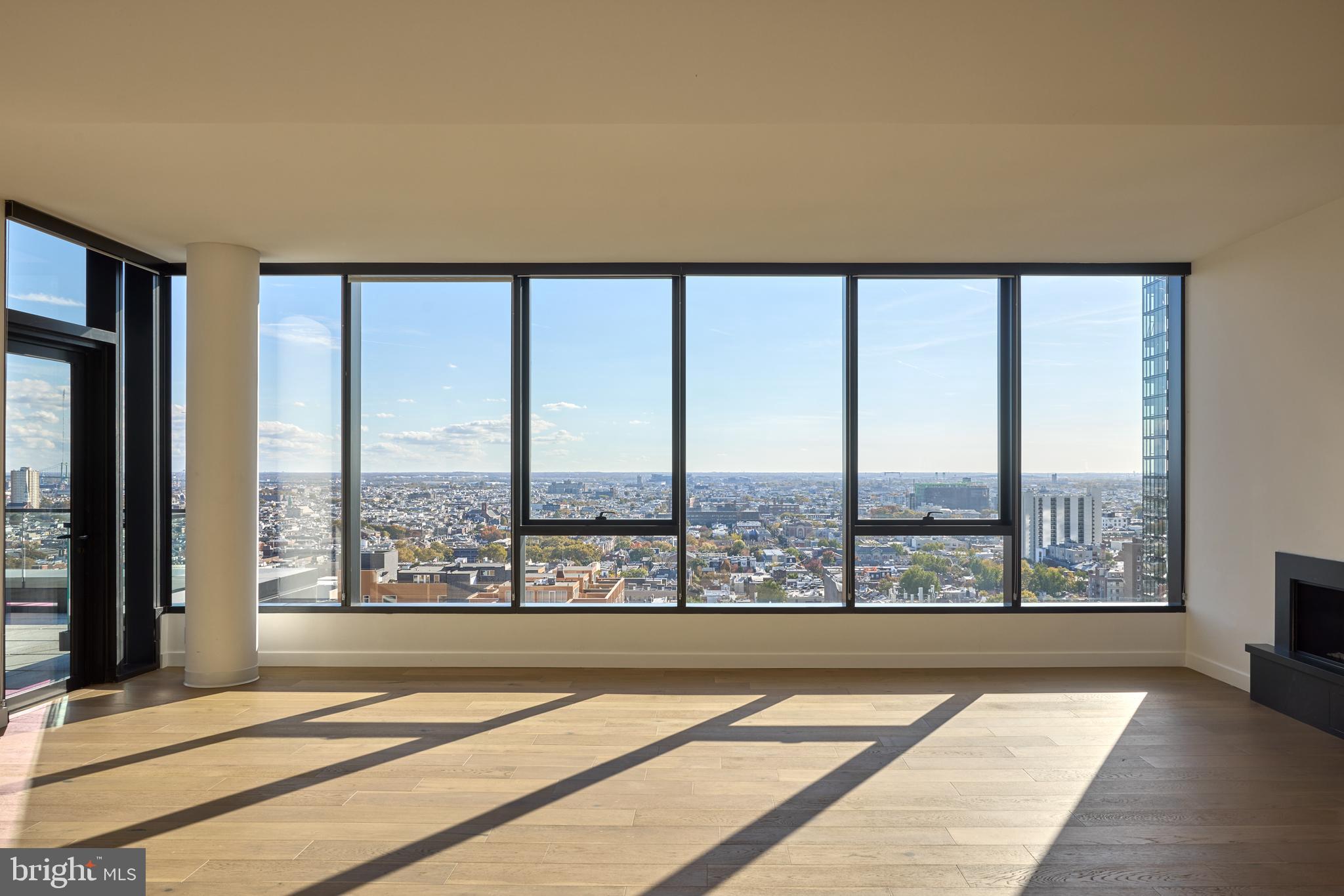 1134 Sansom Street, Unit 3BPH2001 Philadelphia, PA 19107 - Photo 21 of 33 a view of an empty room with wooden floor and a window