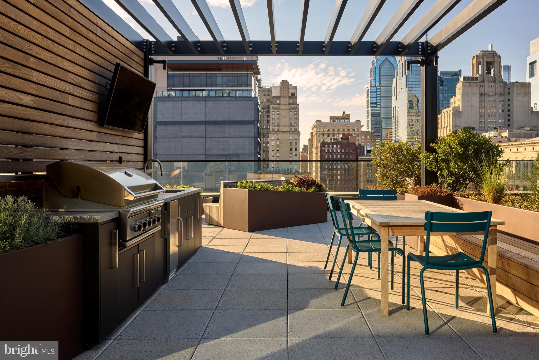 1134 Sansom Street, Unit 3BPH2001 Philadelphia, PA 19107 - Photo 28 of 33 a view of a chairs and table in the back yard of the house