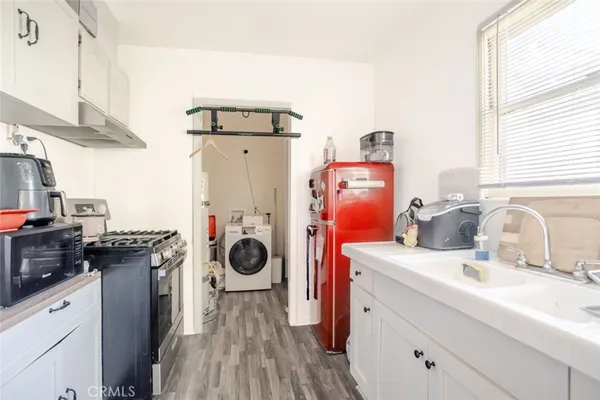 a kitchen with a refrigerator and a stove
