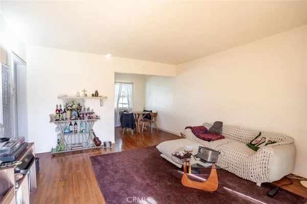 a bedroom with furniture and a wooden floor