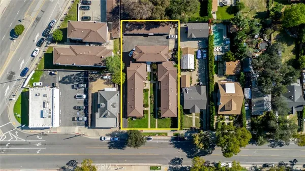 an aerial view of houses with a street