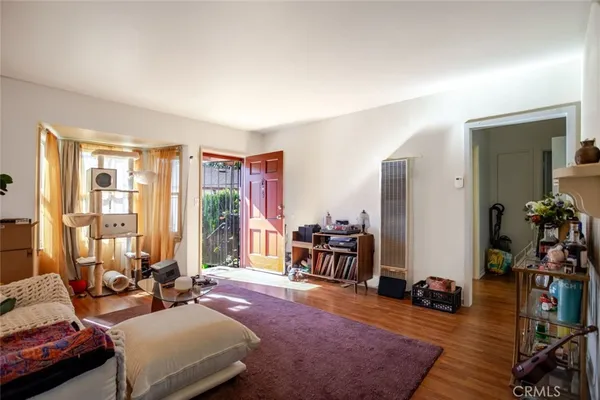 a bedroom with furniture and a large window