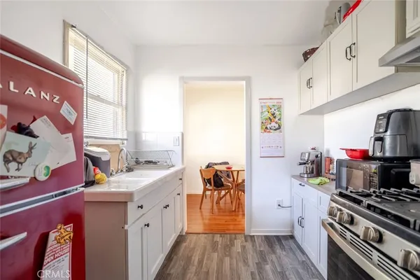 a kitchen with stainless steel appliances a stove a sink and a refrigerator