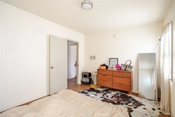 a bedroom with a bed and a dresser