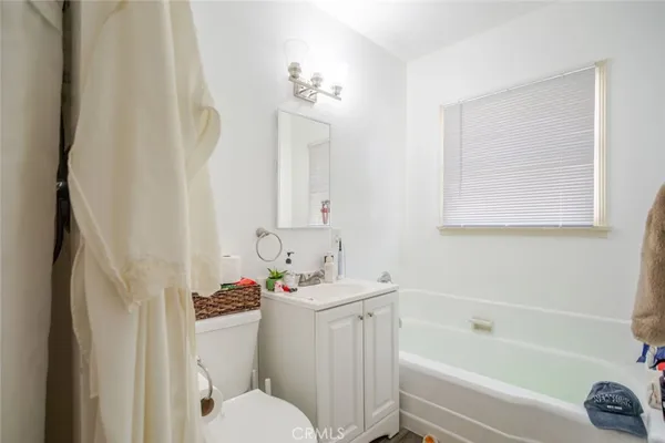 a bathroom with a sink toilet vanity and bathtub