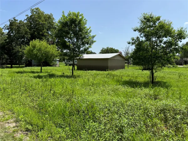 a view of backyard with outdoor seating and green space