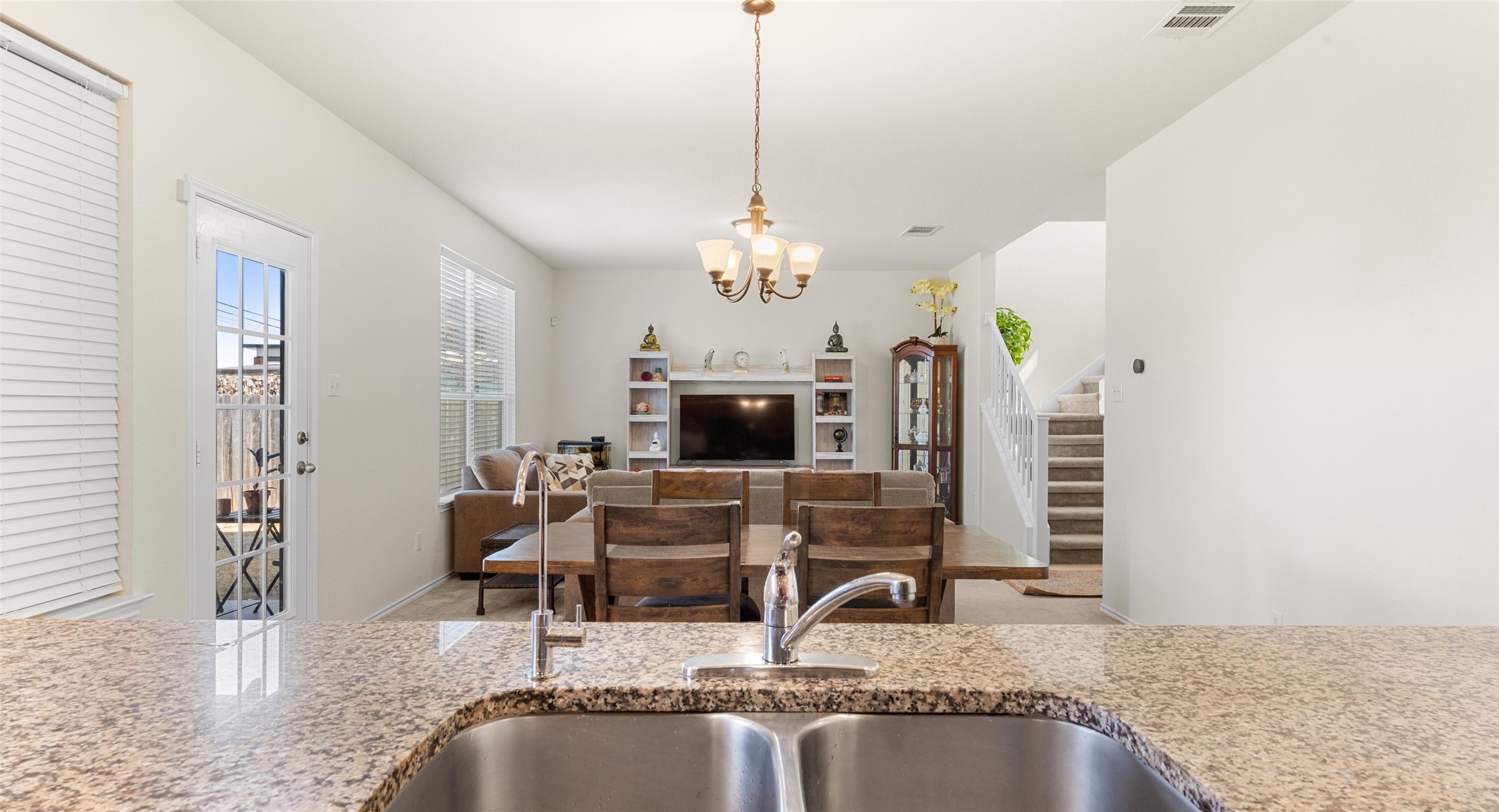 a view of living room with kitchen island granite countertop furniture and fireplace