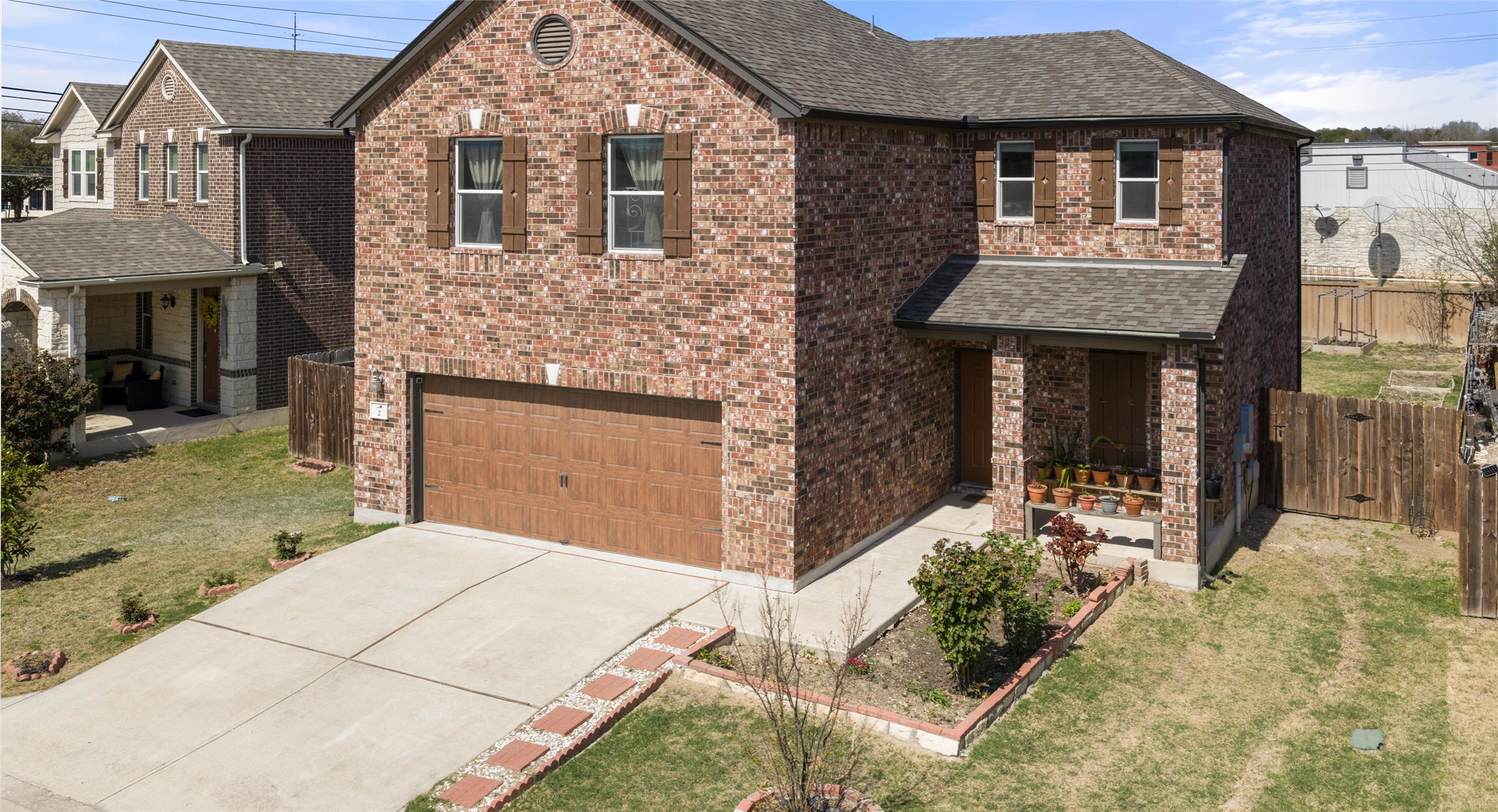2471 Sunrise Road, Unit 2 Round Rock, TX 78664 - Photo 3 of 20 a front view of a house with a garden
