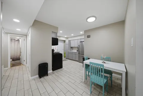 a kitchen with a table and chairs
