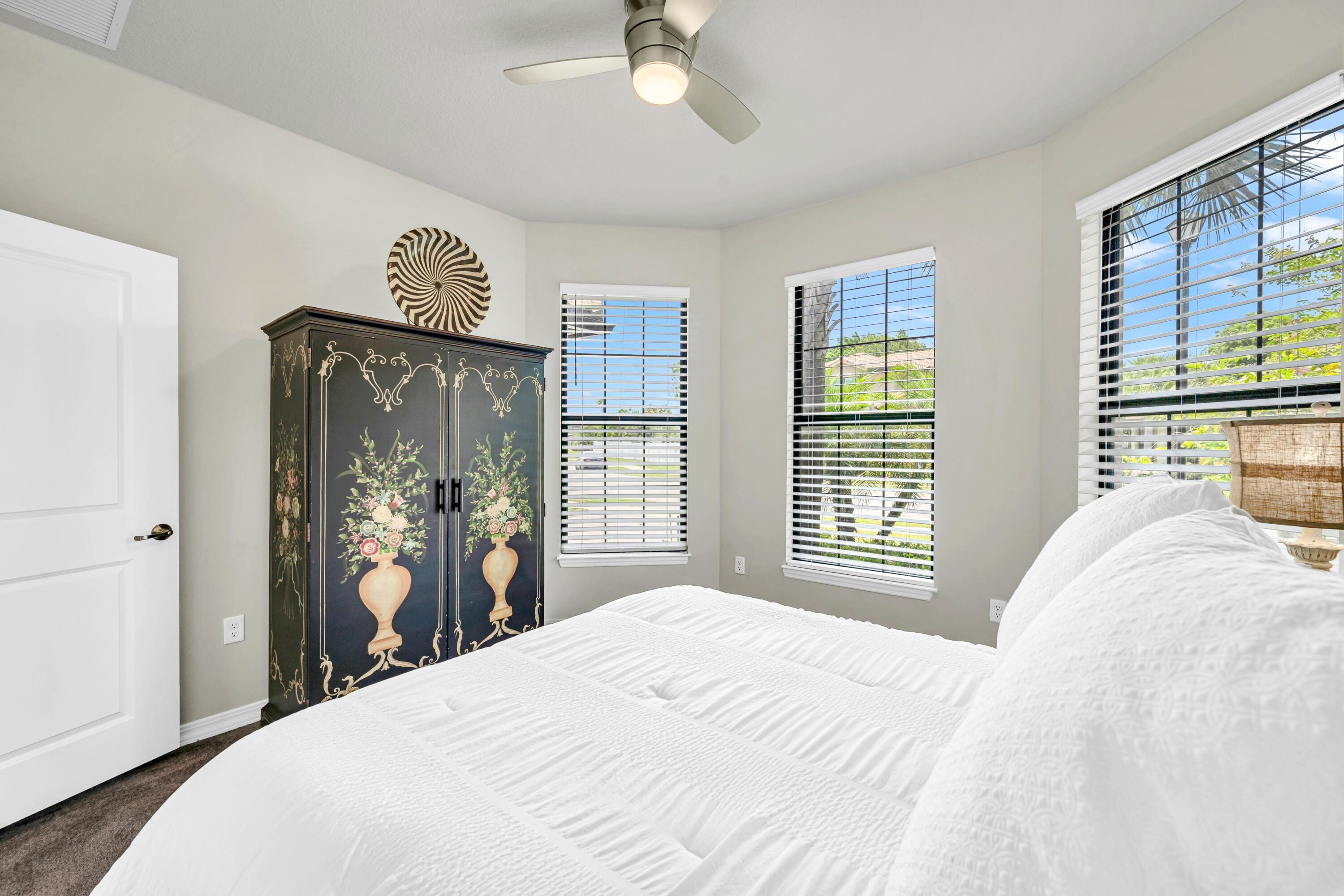 8028 Northwest 78th Street Tamarac, FL 33321 - Photo 15 of 38 a bedroom with a bed and a large mirror with a large window