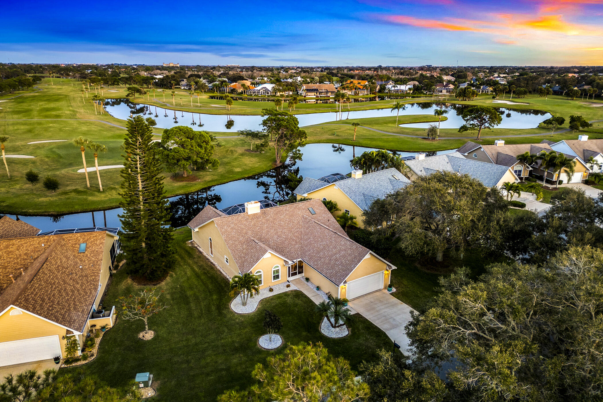 an aerial view of ocean boats and trees