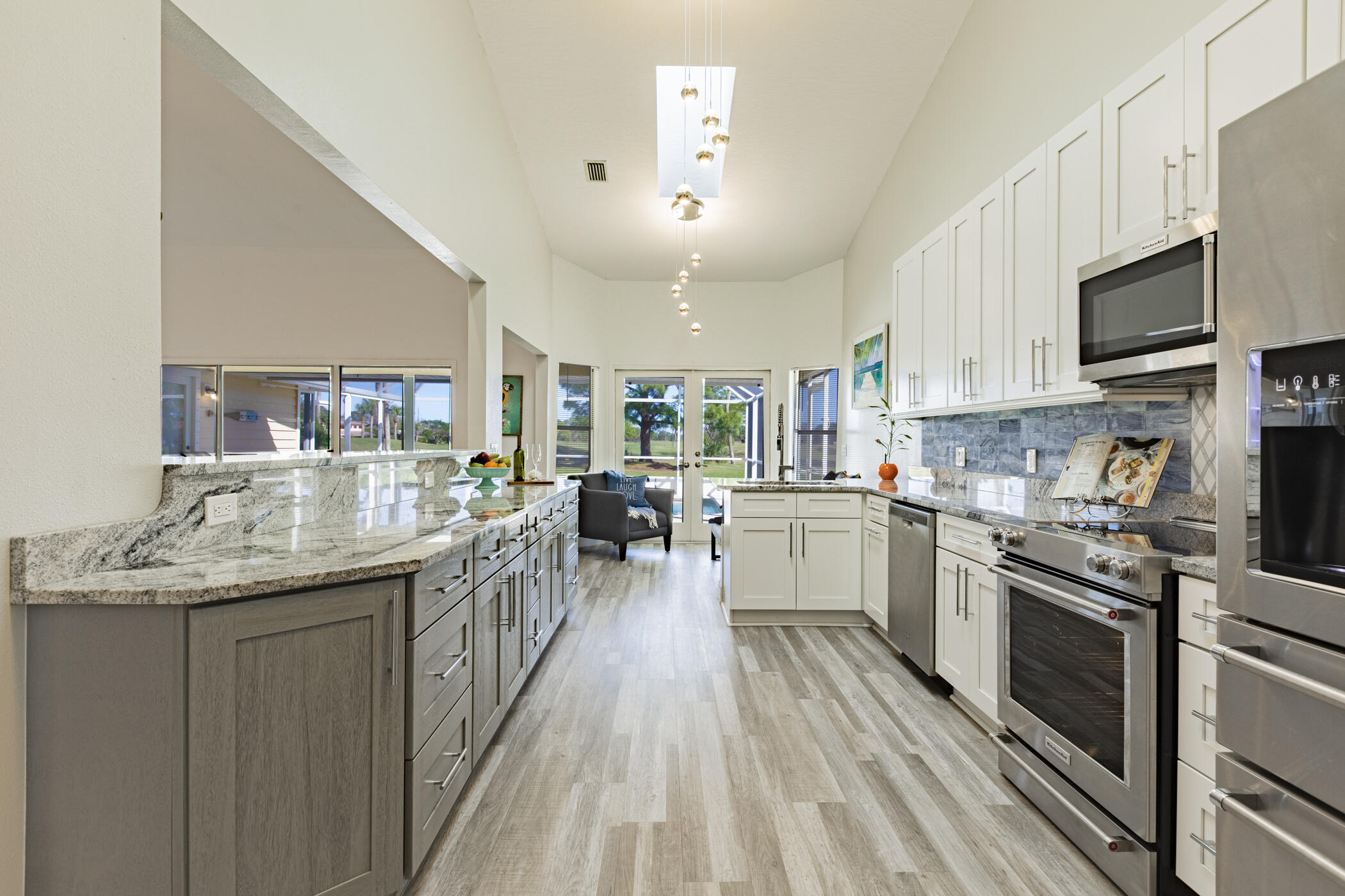 569 Dawson Drive Melbourne, FL 32940 - Photo 12 of 38 a kitchen with granite countertop lots of counter top space a sink stainless steel appliances and cabinets